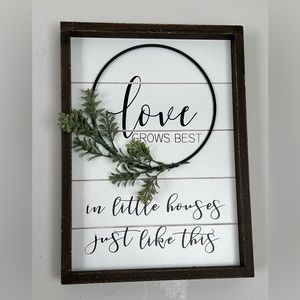 Love grows best in little houses just like this wall sign